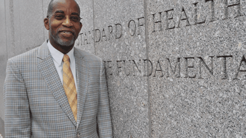 David Williams standing next to granite wall at Harvard Chan School