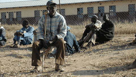 Older man sitting outside in rural South Africa