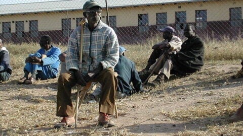 Older man in South Africa sitting in a field