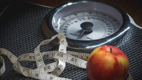 Image of apple, measuring tape, and a scale