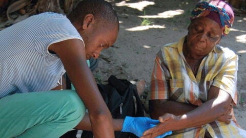 A doctor drawing blood from a woman