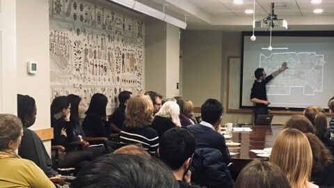 Josh Legewie presenting to a room of people
