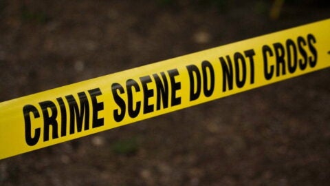 Yellow tape that reads "Crime scene do not cross"