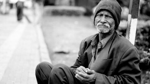 African American man sits on a bench