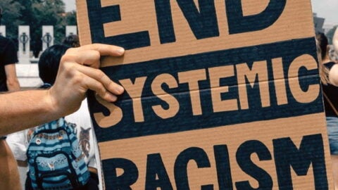 Handwritten sign "End Systemic Racism"
