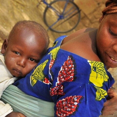 Woman in South Africa with baby on her back