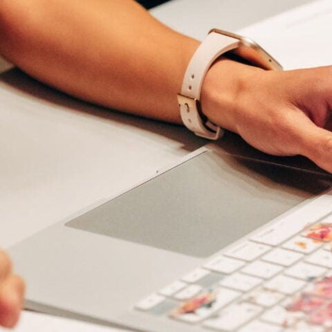 Women with hands on keyboard of laptop