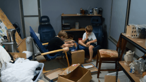 Children play a board game in the middle of moving