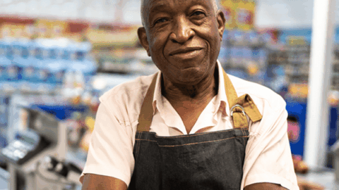Older man of color working in a grocery store