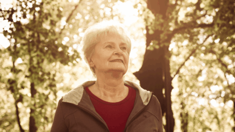 Smiling older woman walking