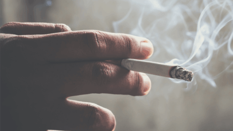 Hand holding a cigarette
